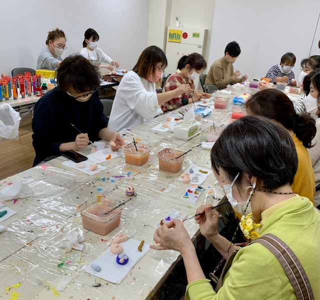 写真：ミモ人形に絵付をしている参加者です。