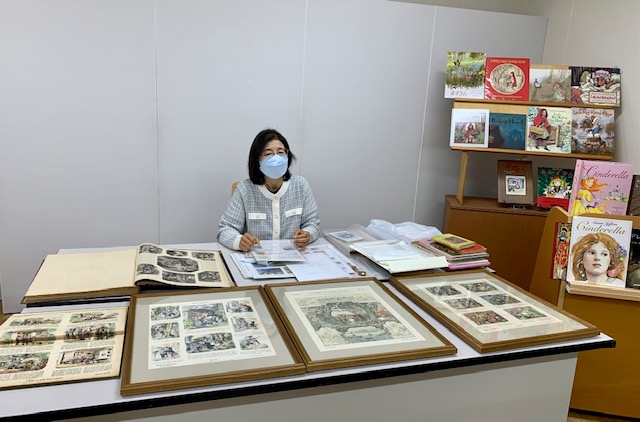 写真：安田幸子さんと額に入った一枚絵です。