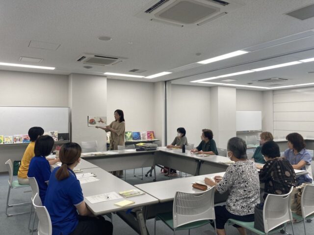 写真：スタッフ大木が絵本の読み聞かせをしています。